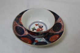 A Worcester polychrome tea bowl and saucer, c.1770, in the Kakiemon palette, decorated with