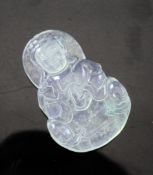 A Chinese translucent `Keng Zhong` jadeite pendant, carved as a seated figure of Guanyin holding a
