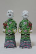 A pair of Chinese famille rose enamelled jostick holders, in the form of boys, Jiaqing period, each