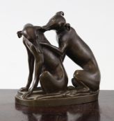 A 19th century French bronze group, modelled as two seated dogs, the oval base signed F.