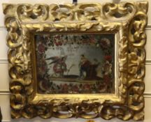 A 19th century Italian carved gilt wood framed mirror, the plate glass painted with an angel and