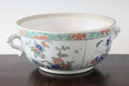 A Chinese famille verte two handled porringer, Kangxi period, painted to four main panels with