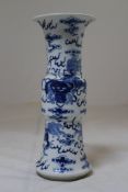 A Chinese blue and white gu vase, Kangxi period, painted with Buddhist lions playing with brocaded