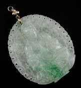 A 1920`s jadeite pendant carved with the figure of Gwan Yin, of oval form, with pierced border and