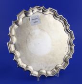 An Edwardian silver salver, of circular form, with piecrust border, on three scroll feet, Walker &