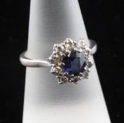 An 18ct white gold sapphire and diamond cluster ring, size O.