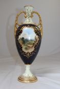 A large Coalport twin handled vase, c.1900, painted by H. Percy, with a named view of Naworth