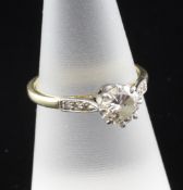 A 1940`s 18ct gold and platinum solitaire diamond ring, with diamond set shoulders, the central