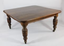 A Victorian oak extending dining table, with four extra leaves, on turned and gadrooned cup and