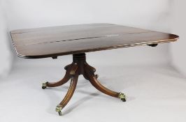 A 19th century mahogany drop leaf dining table, with central turned column, downswept supports and