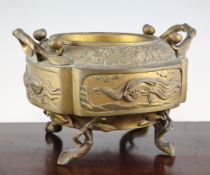 A Japanese bronze two handled jardiniere, cast in relief with dragons, minogame, a phoenix and a