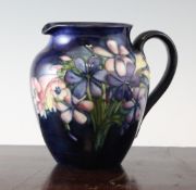 A Moorcroft Spring Flowers ovoid jug, c.1950, with cobalt blue ground, inscribed WM and other