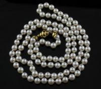 A single strand cultured pearl necklace with turned clasp, 36in.