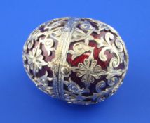 A late 19th/early 20th century Swiss? gold and red guilloche enamel egg shaped pill box, with