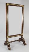 A 19th century mahogany ormolu mounted cheval mirror, with cushion shaped frame, on scrolling legs