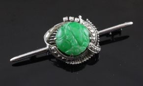 A 14ct white gold and carved jadeite bar brooch, 2in.