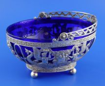 A late 19th century Hanau 800 standard pierced silver basket with blue glass liner, decorated with