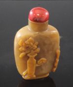 A Chinese jasper cameo snuff bottle, 1760-1880, carved in high relief with a vase of flowers, a