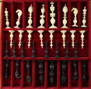 A late 19th century Indian carved ivory chess set, with natural opposing black stained ivory