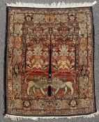 An Isphahan Tree of Life rug, with symmetrical field, with lions, on a burnt orange ground, with