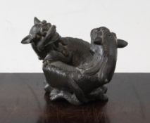 A Chinese bronze twin lion-dog scroll weight, 19th century, each entwined in recumbent pose, 8cm.