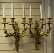 A pair of rococo style ormolu three branch wall lights, with scrolling acanthus decoration, overall
