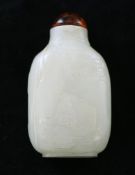 A Chinese white and black speckled jade snuff bottle, 1780-1850, the front carved in low relief