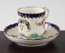 A Worcester polychrome fluted coffee cup and saucer, c.1770 decorated with painted floral sprays