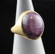 A Chinese gold and star ruby set ring, of oval form, size I.