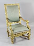 A Louis XIV style carved giltwood high back fauteuil, with lattice patterned upholstered back and