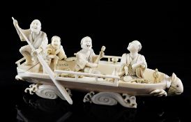 A large Japanese ivory okimono of three men and a boy on a boat, Meiji / Taisho period, the man at