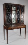 A George III mahogany breakfront display case, with four astragal glazed doors over three drawers,