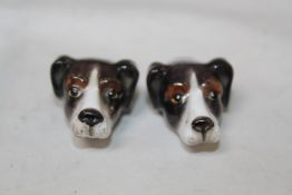 A pair of Royal Worcester hound head whistles, c.1937, the heads with brown and white markings,