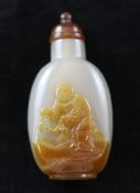 A Chinese chalcedony cameo snuff bottle, 20th century carved in high relief to a russet inclusion