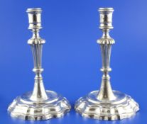 A pair of 18th century Venetian cast silver candlesticks, with demi-fluted knopped stems, on shaped