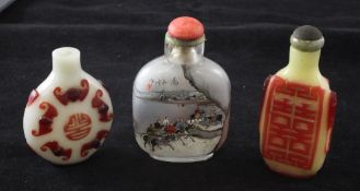 Three Chinese glass snuff bottles, 1800-1940, the first in ruby and white overlay carved to each