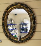 A Victorian oval gilt wall mirror, the frame decorated a continuous band of acorn and oak leaves,
