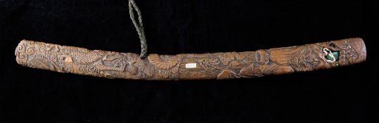 A Japanese carved wood Bokuto doctor`s sword, 19th century, carved in relief with a dragon emerging