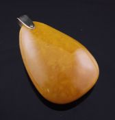 A free form yellow amber pendant, gross 28 grams, 2.5in.