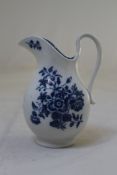 A Worcester blue and white `Three Flowers` pattern milk jug, c.1775, the helmet shape printed in