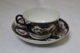 A Worcester blue scale ground coffee cup and saucer, decorated with painted exotic birds and