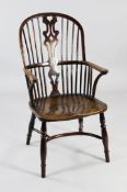 A 19th century yew and elm Windsor armchair, with pierced central splat, on turned supports united