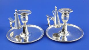 A pair of George III silver chambersticks, with engraved armorial and reeded borders, William