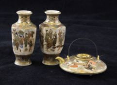 A Japanese Satsuma miniature teapot and a pair of hexagonal baluster vases, Meiji period, the