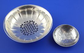 A 19th century pierced silver dish, of circular form, with engraved armorial and fluted decoration,