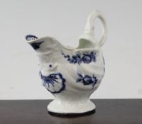 A Worcester dolphin sauceboat, c.1755, moulded as a shell on a round pedestal foot, painted in