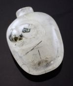 A Chinese rock crystal snuff bottle, 1760-1880, with `hair` inclusions, carved in high relief to