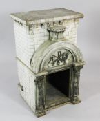 A grey painted French architectural altar piece, with an arched door pediment, columns and open