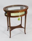 An Edwardian mahogany and boxwood strung oval bijouterie table, with shaped square section supports