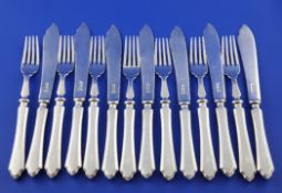 A set of seven pairs of George V silver fish eaters, with engraved insignia?, Mappin & Webb,